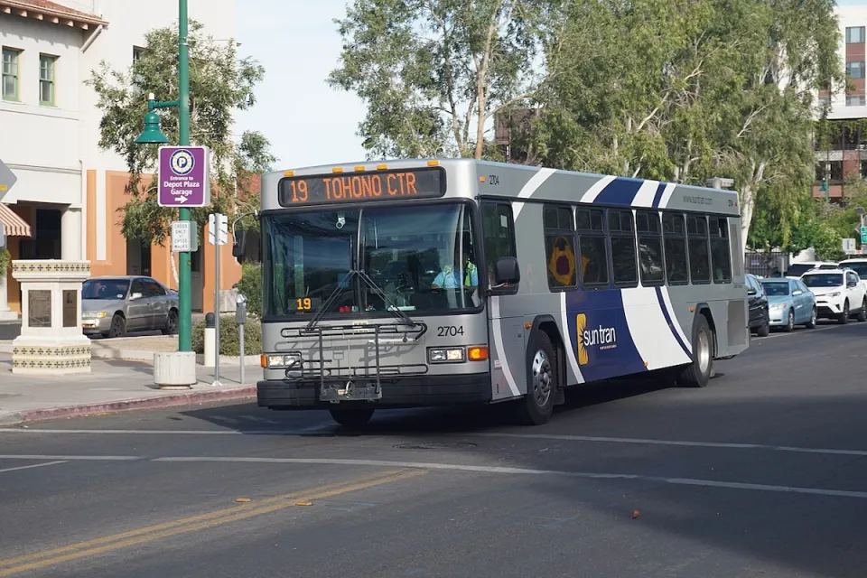 Silver and blue Sun Tran public transit bus on street in Tucson, Arizona.